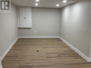Niagara Falls (Church's Lane) apartment for rent - A room with wooden flooring and white walls, with a cabinet on the wall.