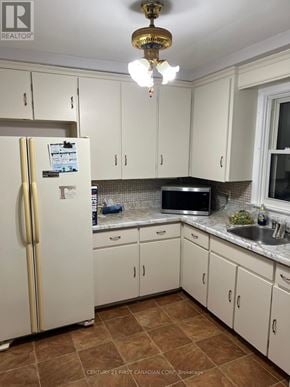 London East (East H) apartment for rent - A kitchen with white cabinets and a white fridge.