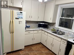 London East (East H) apartment for rent - A kitchen with a white fridge and cabinets.