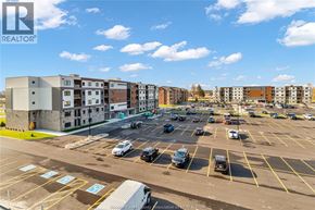 Lasalle condo for rent - A parking lot with cars and apartment buildings in the background.