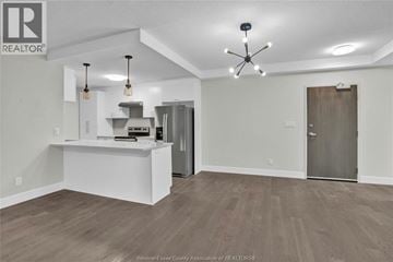 Lasalle condo for rent - A spacious kitchen area with a white counter and a ceiling fan.