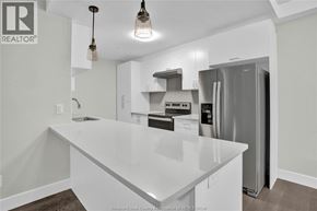 Lasalle condo for rent - A kitchen with a white countertop and a refrigerator.