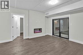 Lasalle condo for rent - A spacious room with a fireplace and sliding glass doors.