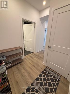 Waterloo condo for rent - A hallway with a black and white rug on the floor.
