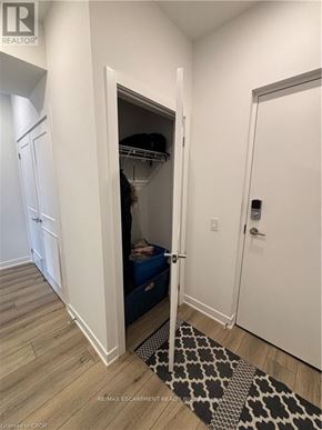 Waterloo condo for rent - A white door with a black and white rug in front of it.