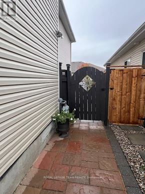 Ottawa apartment for rent - A black gate with a diamond pattern in the middle is closed.