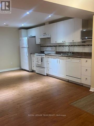 Ottawa apartment for rent - A kitchen with white cabinets and appliances.