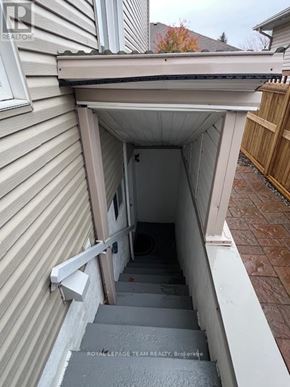 Ottawa apartment for rent - A stairway leading to a door under a porch.
