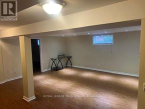 Ottawa apartment for rent - A room with wooden floors and a window with blinds.