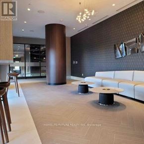 Oshawa (Windfields) condo for rent - A modern living room with a white sofa and a wooden floor.