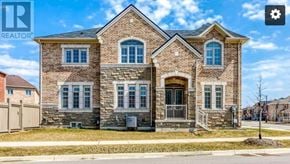 Oakville (Jm Joshua Meadows) apartment for rent - A large brick house with a gated driveway in front.
