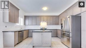 Oakville (Jm Joshua Meadows) apartment for rent - A modern kitchen with stainless steel appliances and wooden cabinets.