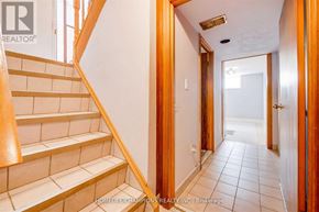 Toronto (Downsview-Roding-Cfb) apartment for rent - A hallway with a staircase on the left and a door on the right.