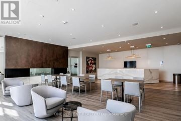 Mississauga (City Centre) condo for rent - A modern living room with a fireplace and a dining table set up.