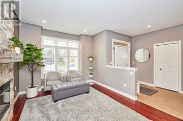 Welland (Coyle Creek) apartment for rent - A living room with a grey couch and a fireplace.