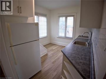 Woodstock apartment for rent - A kitchen with a white fridge and a black counter top.