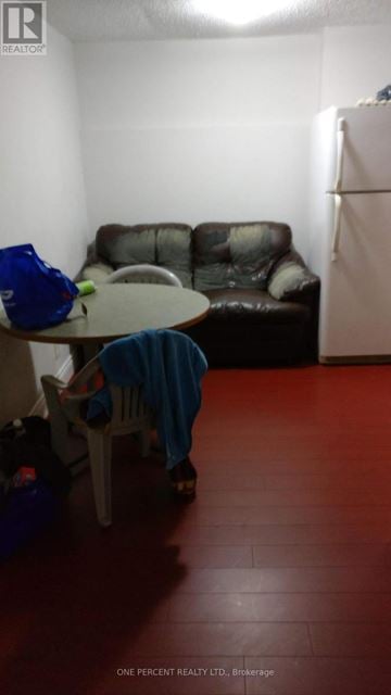 Brampton (Fletcher's Creek South) apartment for rent - A living room with a brown couch and a blue chair.