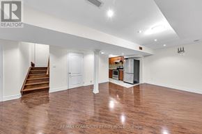 Markham (Legacy) apartment for rent - A spacious room with wood flooring and white walls.