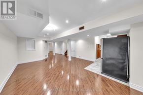 Markham (Legacy) apartment for rent - A spacious room with wooden flooring and white walls.