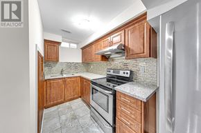 Markham (Legacy) apartment for rent - A kitchen with wooden cabinets and a granite countertop.