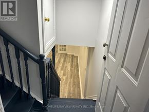 Vaughan (Maple) apartment for rent - A staircase with a black railing and white walls.
