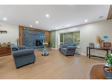 Delta apartment for rent - A living room with a grey couch and a glass coffee table.