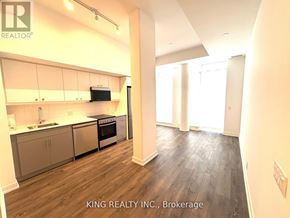 Toronto (Birchcliffe-Cliffside) condo for rent - A kitchen with a stove top oven and a microwave built into the cabinetry.