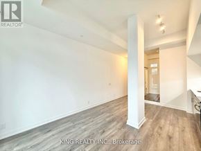 Toronto (Birchcliffe-Cliffside) condo for rent - A spacious room with wooden flooring and white walls, part of a property listing by King Realty Inc. in Brokerage.