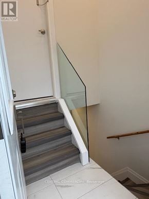 Aurora (Aurora Highlands) apartment for rent - A staircase with a glass railing and wooden steps.