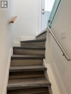 Aurora (Aurora Highlands) apartment for rent - A staircase with a glass railing and wooden steps.