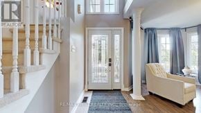 Barrie (East Bayfield) apartment for rent - A white chair is in front of a door with a glass panel.