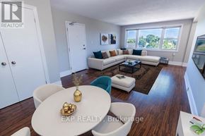 St. Catharines (E. Chester) multi-family for rent - A well-lit living room with a white dining table and a white sofa.