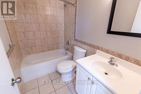St. Catharines (E. Chester) multi-family for rent - A bathroom with a white toilet, a white sink, and a white bathtub.