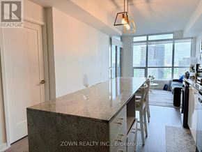 Toronto (Bayview Village) condo for rent - A kitchen with a granite countertop and a bar stool.