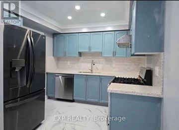 Mississauga (Meadowvale Village) house for rent - A kitchen with blue cabinets and a stainless steel refrigerator.