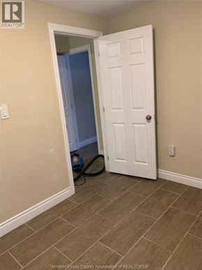 Windsor apartment for rent - A room with a white door and a vacuum cleaner on the floor.
