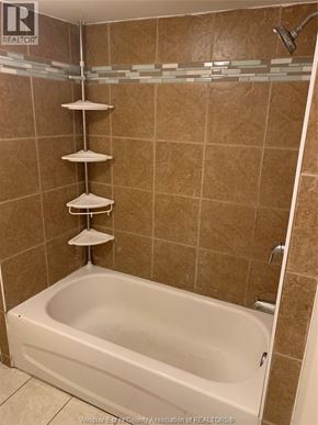 Windsor apartment for rent - A bathroom with a bathtub and a shower.