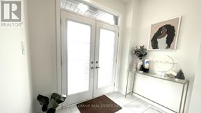 Haldimand apartment for rent - A room with a white door, a white bench, and a painting of a woman.