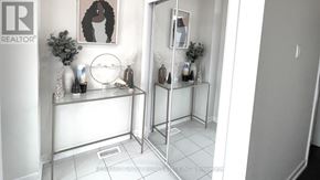 Haldimand apartment for rent - A bathroom with a glass shower door and a white tiled floor.