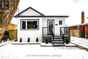 Hamilton (Burkholme) apartment for rent - A small white house with a black roof and a black railing on the porch.