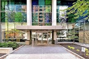Toronto (Bay Street Corridor) condo for rent - The image shows a modern building entrance with glass walls and a concrete structure.