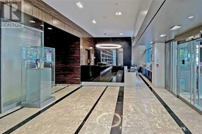 Toronto (Bay Street Corridor) condo for rent - A spacious lobby with a marble floor and a glass wall.