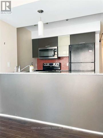 Toronto (Bay Street Corridor) condo for rent - A kitchen with a stove top oven and microwave.