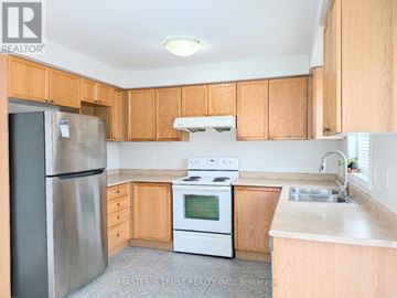 Newmarket (Woodland Hill) apartment for rent - A kitchen with wooden cabinets and a stainless steel refrigerator.