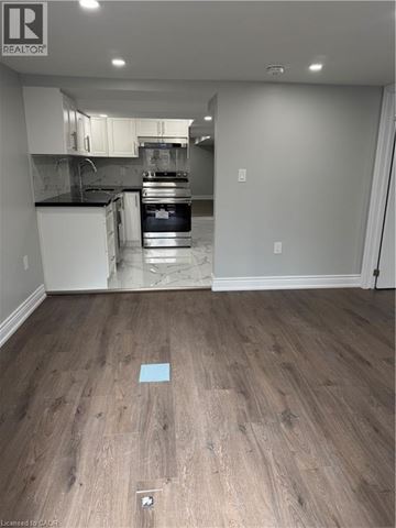 Hamilton apartment for rent - A kitchen with a white oven and a white fridge.