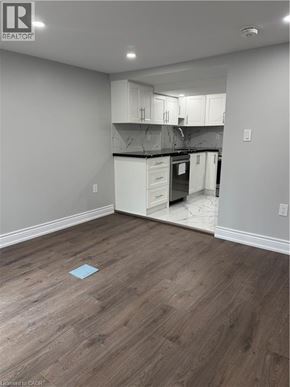 Hamilton apartment for rent - A kitchen with white cabinets and a wooden floor.