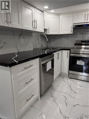 Hamilton apartment for rent - A kitchen with white cabinets and marble countertops.