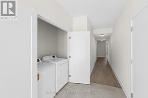 Brockville apartment for rent - A white laundry room with a washer and dryer.