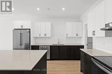 Brockville apartment for rent - A kitchen with white cabinets and a black island.