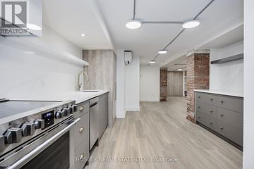 Toronto (Little Portugal) apartment for rent - A modern kitchen with a stainless steel stove and wooden flooring.